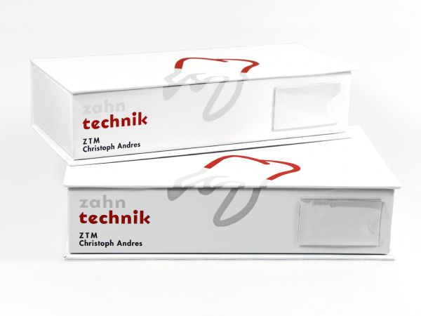 Weiße Verpackung für 2 Zahnmodelle und Dentalprodukte mit Buchdeckel und Logo-Aufdruck. Mit transparenter Hülle aus Kunststoff für ein Patientenkärtchen